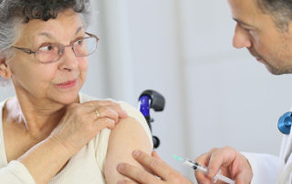 A senior woman getting a vaccine