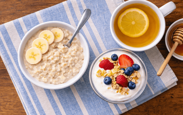 senior nutrition - oatmeal with banana, greek yogurt with berries, ginger lemon tea