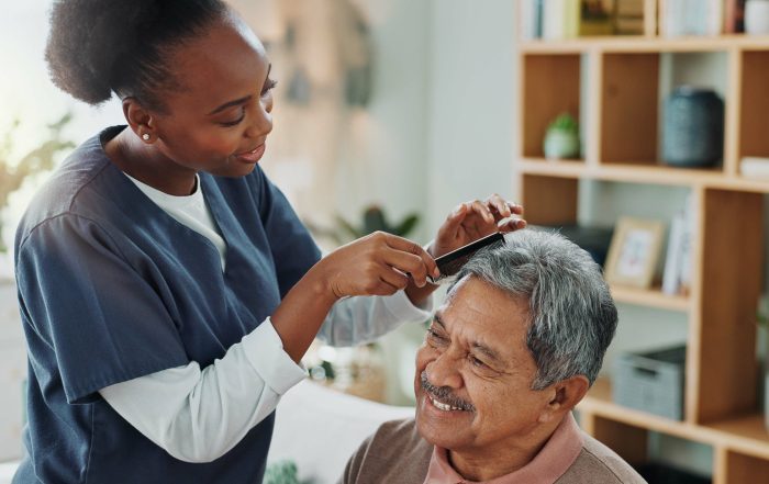 parkinson's disease client getting assistance with personal grooming with hair combing