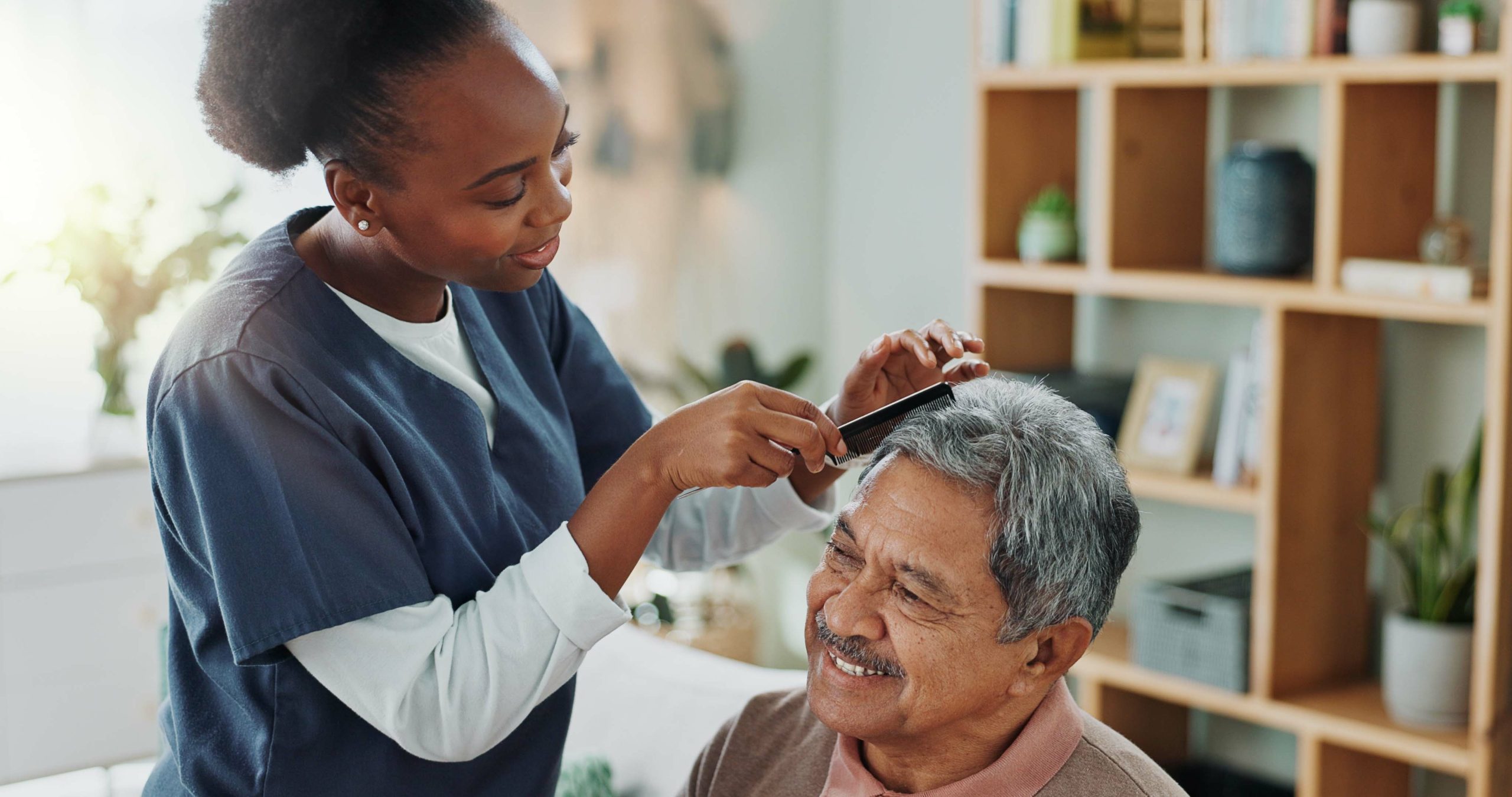 parkinson's disease client getting assistance with personal grooming with hair combing
